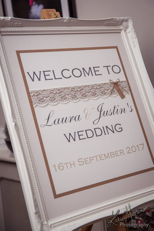 Wedding welcome sign decorated with burlap lace twine displayed in ornate white frame