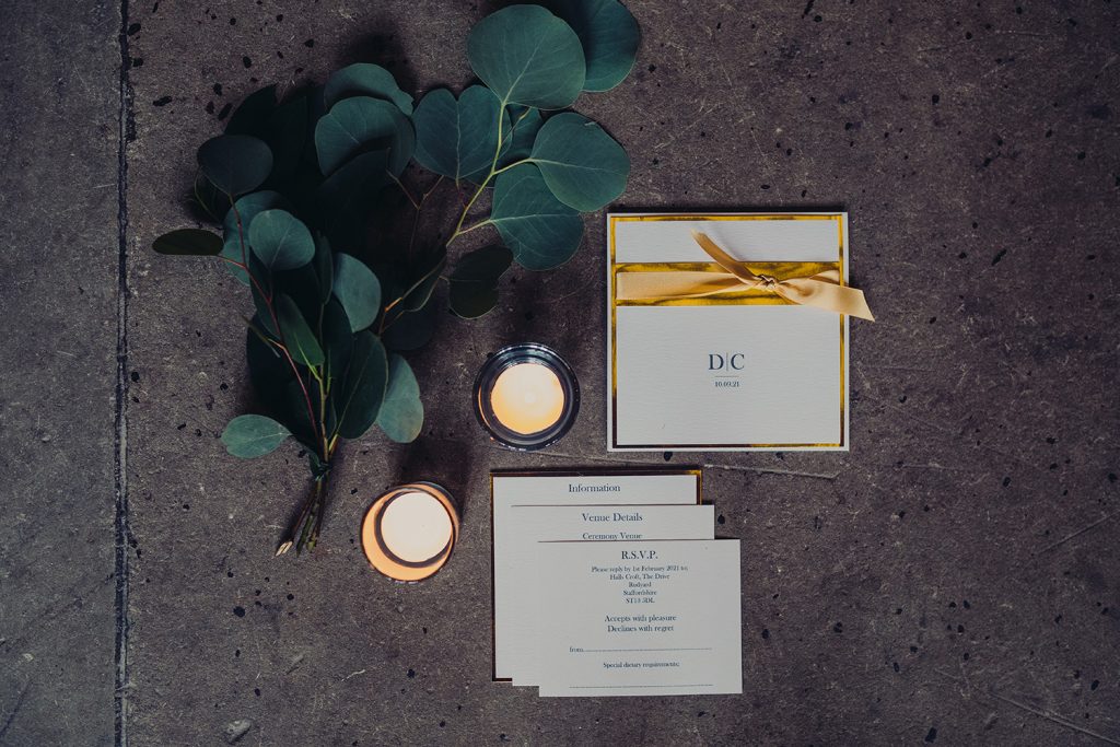 wedding planning wedding invitation gold foil gold ribbon inserts foliage candles stone floor