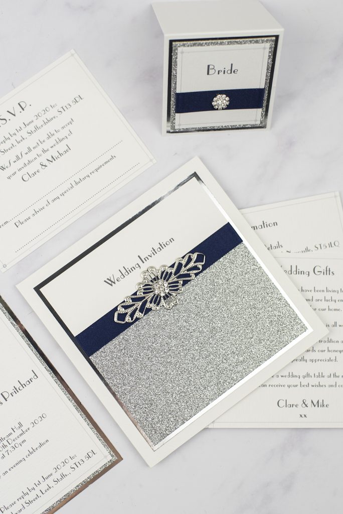 luxury wedding invitations silver glitter wire crystal embellishment pocketfold flat lay