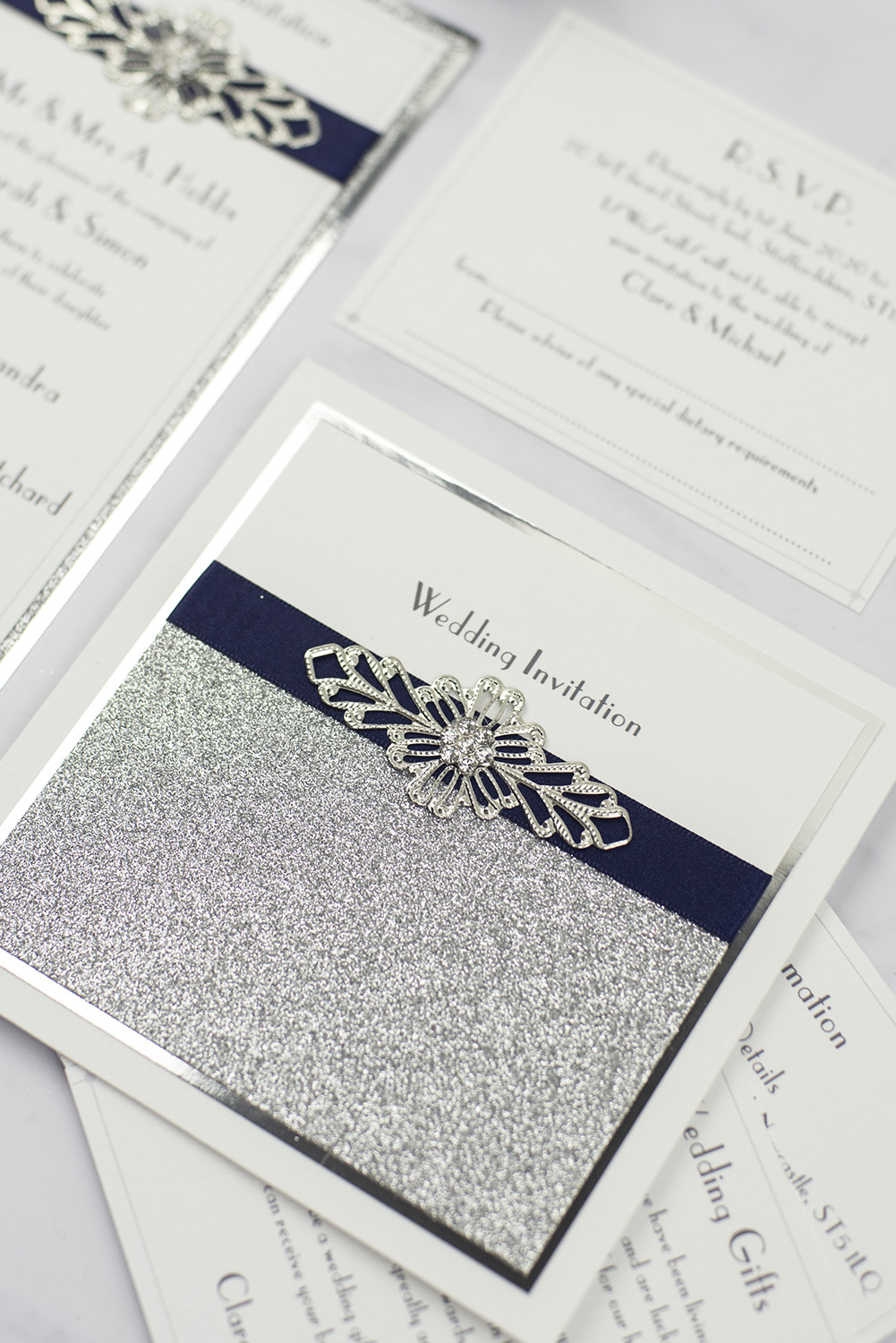 luxury wedding invitations white silver glitter foil navy ribbon wire embellishment pocketfold invitation