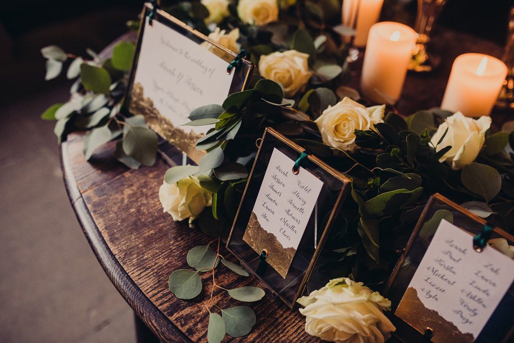 wedding checklist gold frames table plan gold leaf roses foliage candles