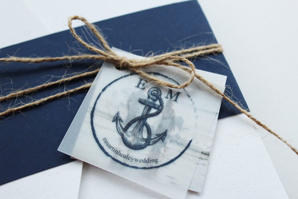 diy wedding invitations close up navy belly band twine bow vellum logo tag