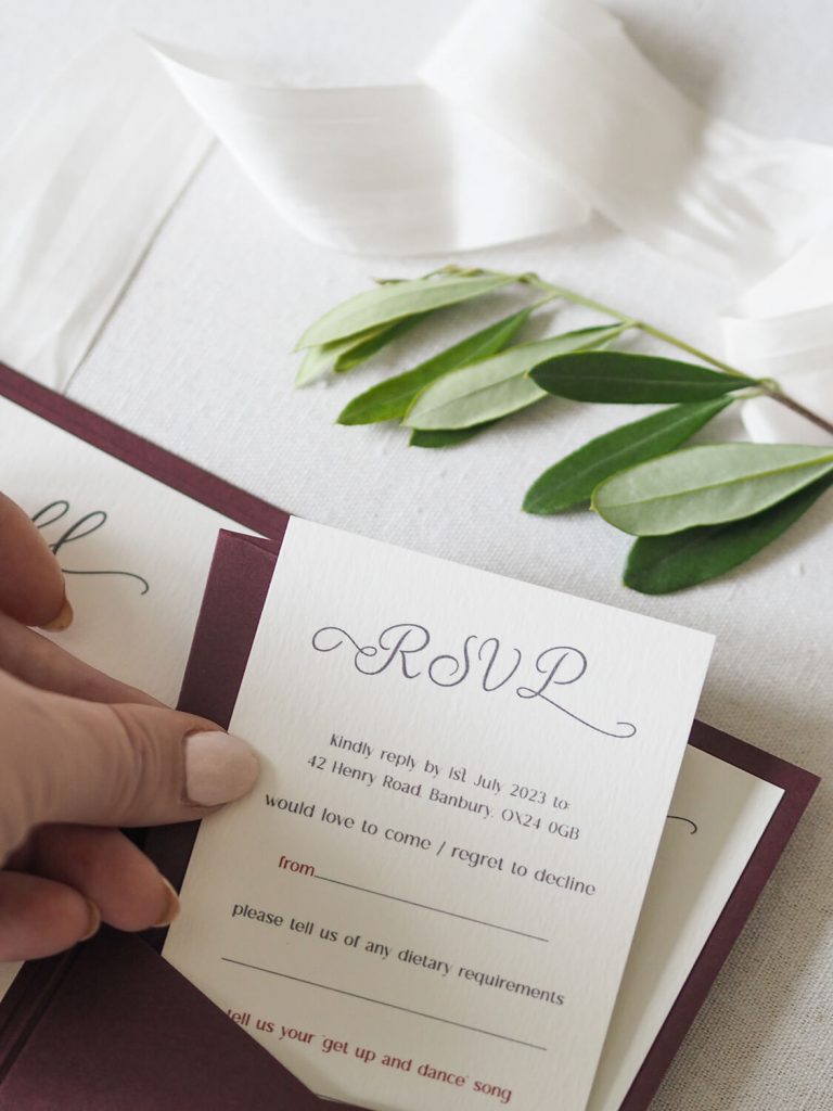 hand holding rsvp card taking out of pocket in wedding  invitation 