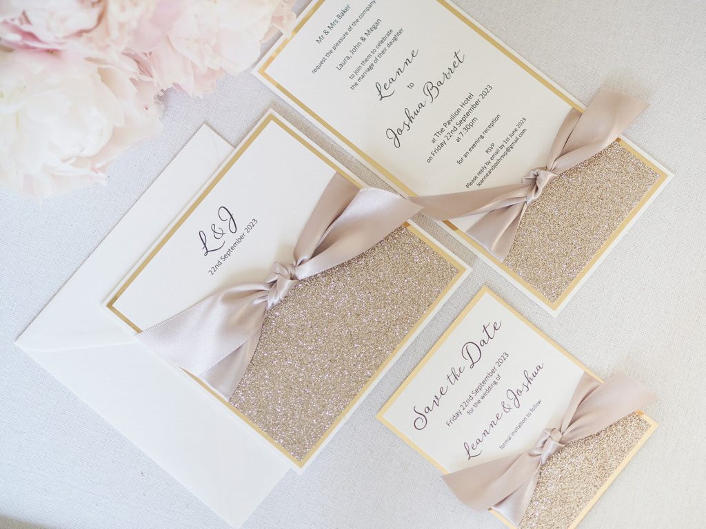 flat lay wedding invitation suite champagne glitter large champagne satin ribbon bow matching flat invitation save the date